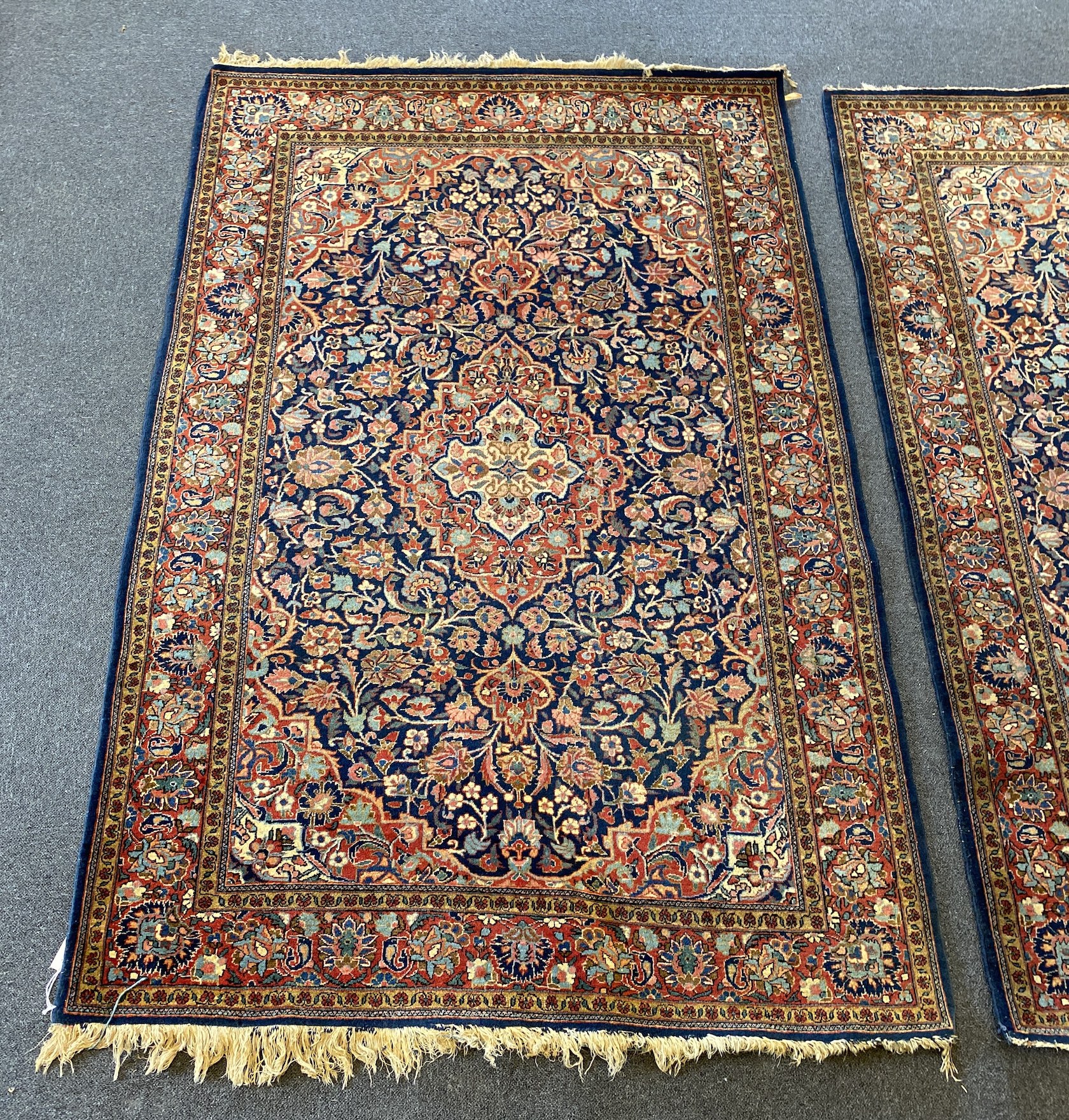 A pair of Kashan blue ground rugs, 213 x 139cm